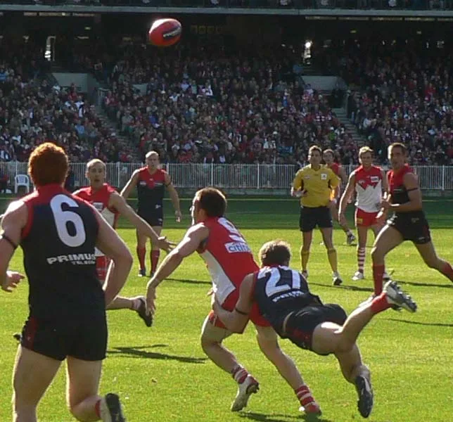 AFL player in tackle contest on field