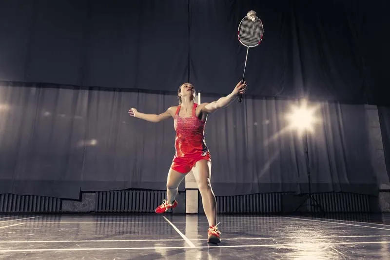 Badminton player preparing to return shot on court
