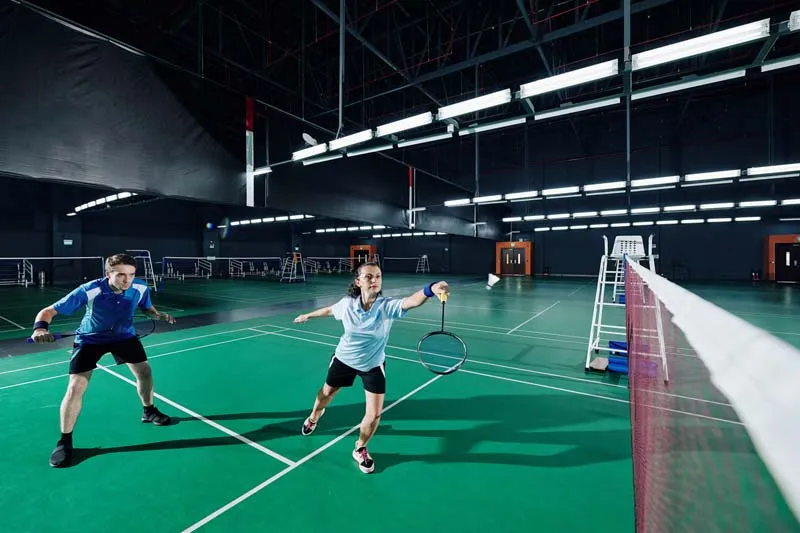 Badminton player ready on court during intense match