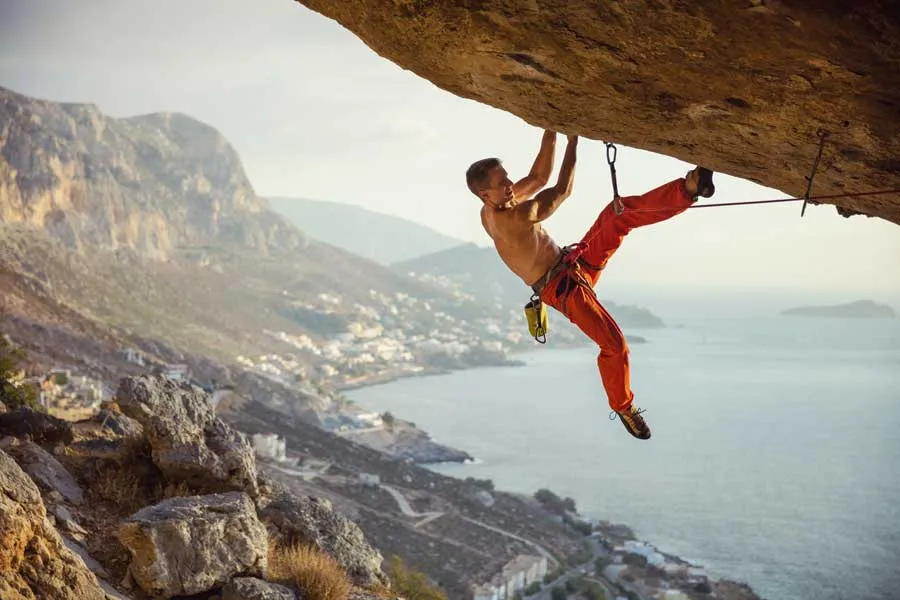 Climber attempting a challenging cave route