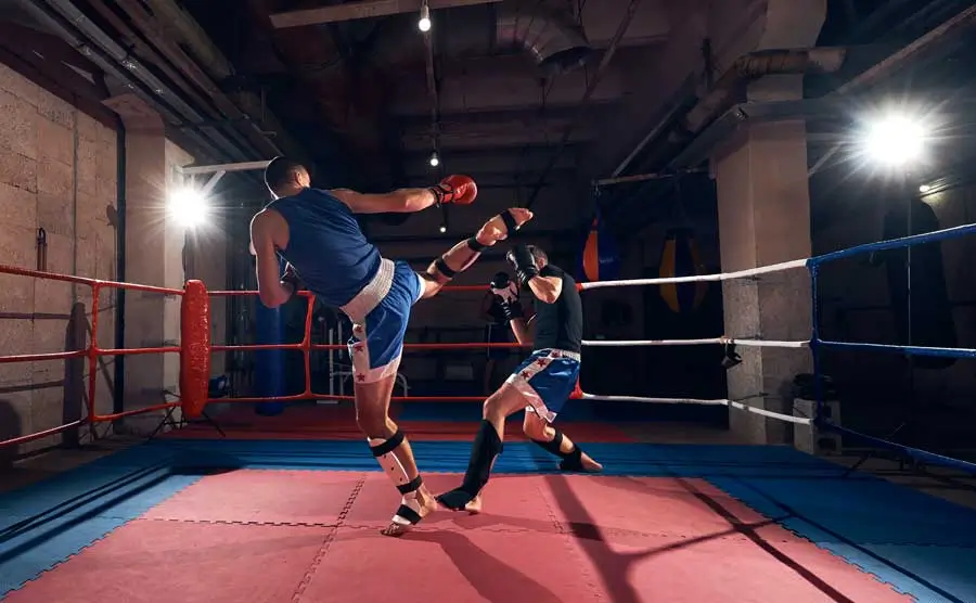 Boxers practising kickboxing in a ring