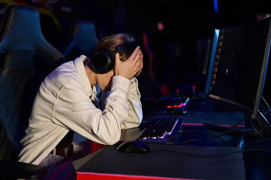 Frustrated gamer in headphones experiencing tilt