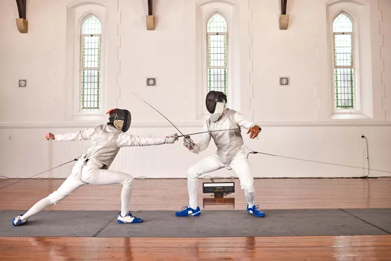 Fencers in competitive bout on piste