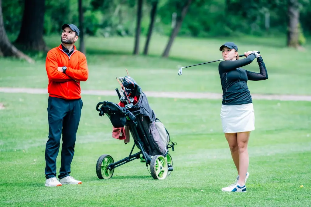Golf training young ladies with instructor