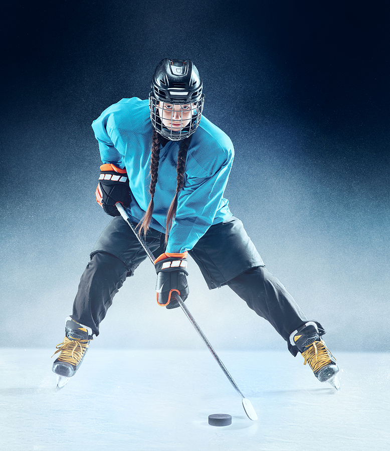 Young female hockey player with stick