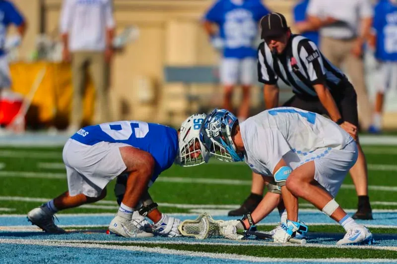 Lacrosse players competing during intense match