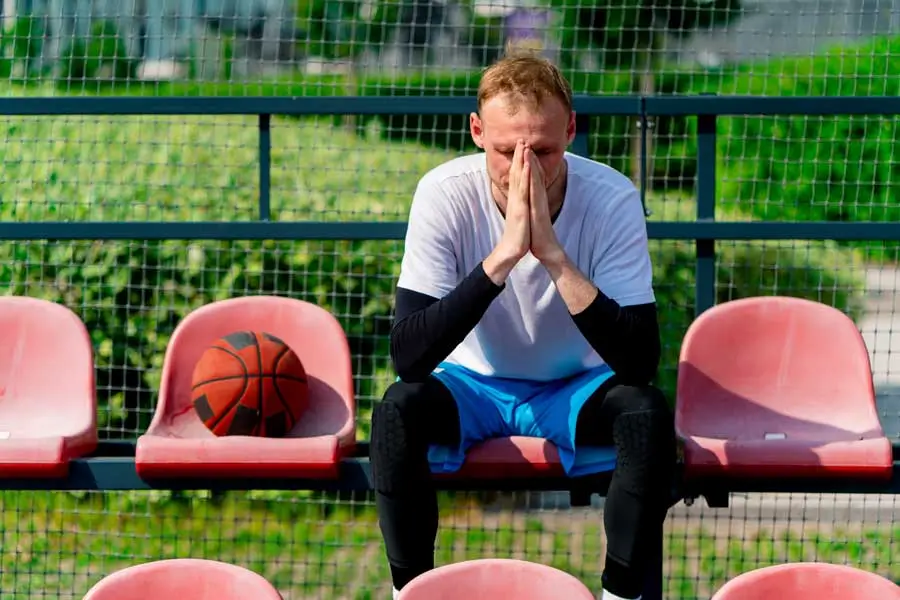 tall frustrated guy basketball player sitting in t 2024 12 01 23 16 04 utc