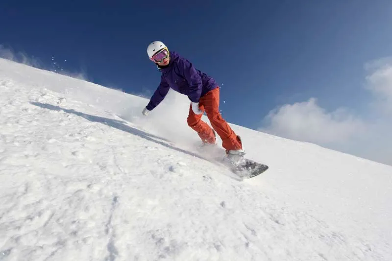 Snowboarder descending a mountain