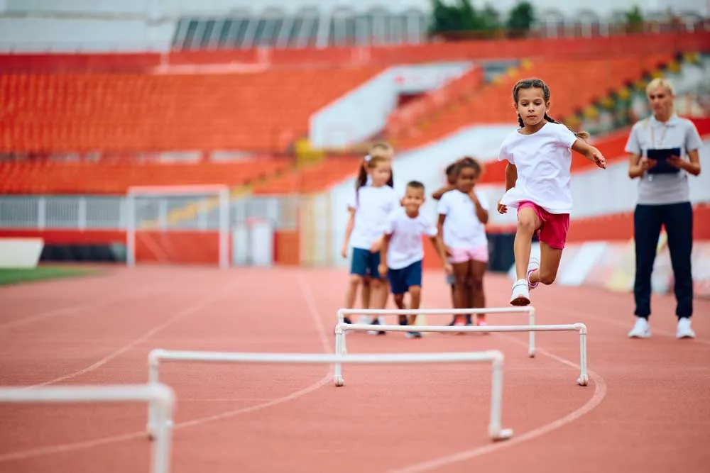 Copy of little girl jumping over hurdle during pe class at 2024 12 13 22 16 56 utc
