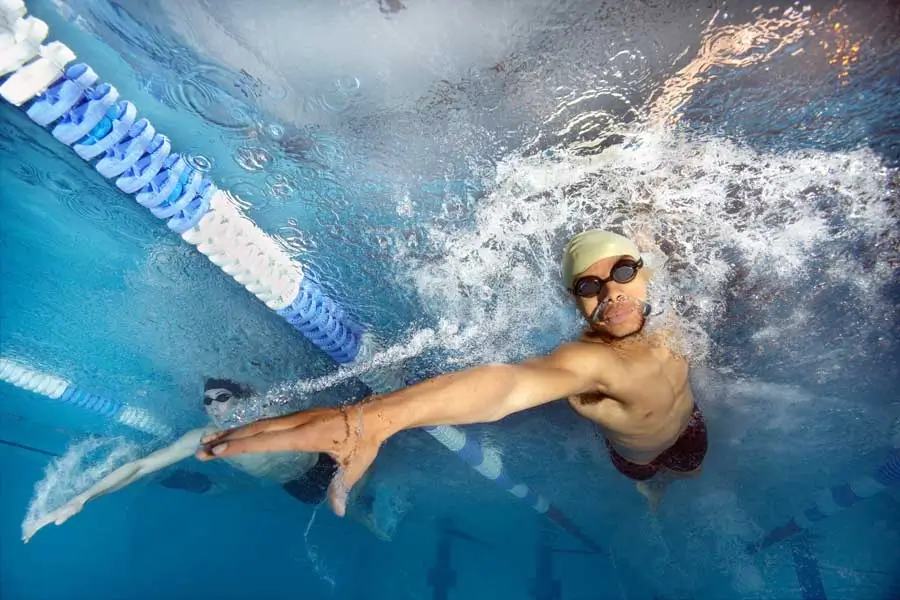 Swimmers racing in pool with mental resilience