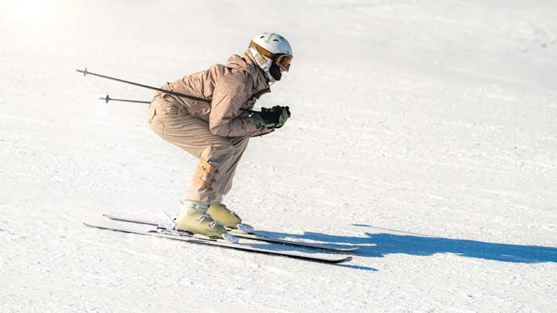 Skier descending a snowy mountain slope